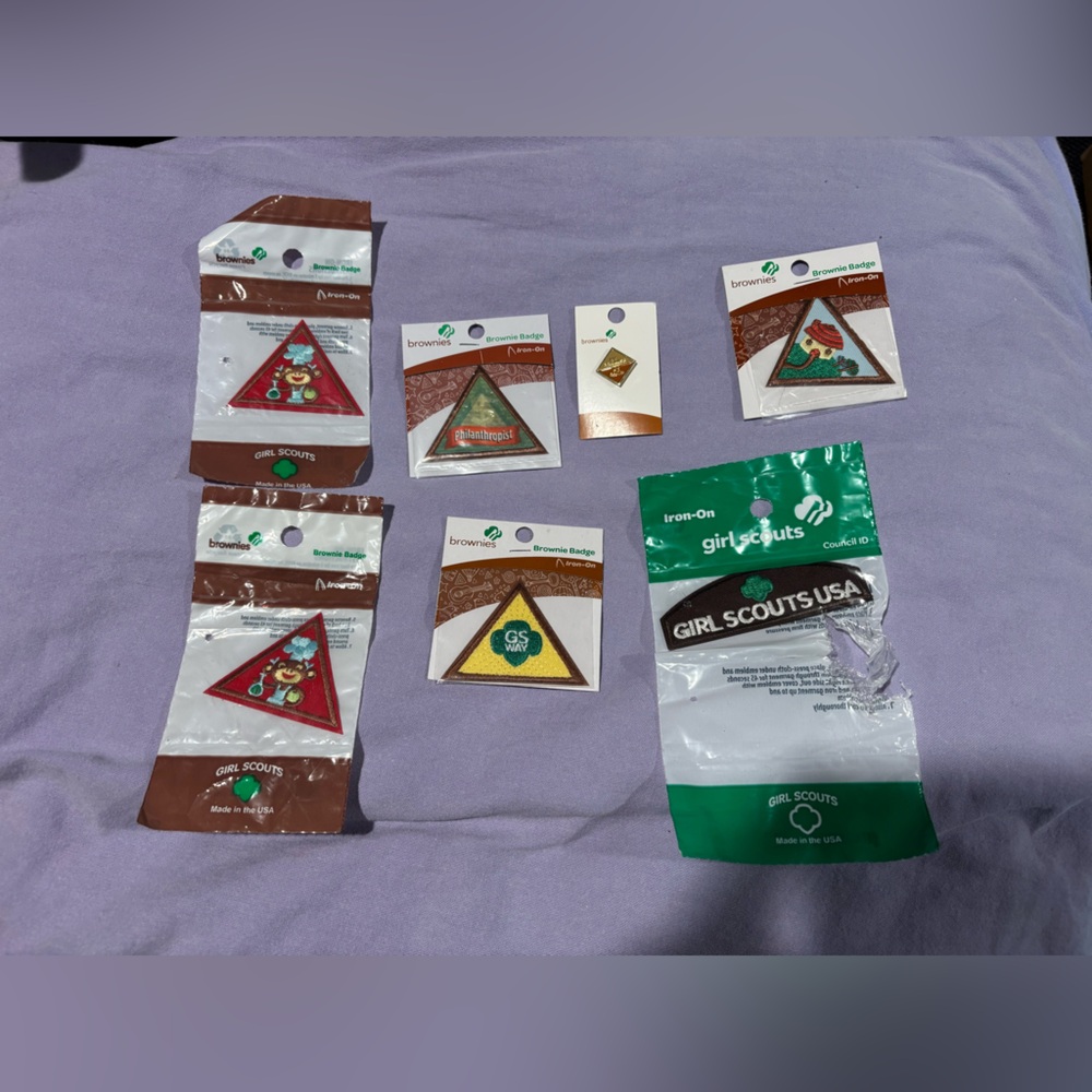 Girl Scouts Brownie insignia, badges, and a pin. NWT.